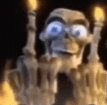 a blurry picture of a skeleton with candles in front of it