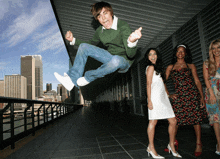 a man in a green sweater is jumping in the air in front of a group of women