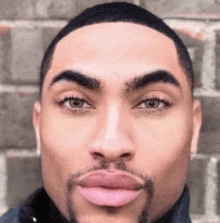 a close up of a man 's face with a beard and big lips .