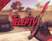 a person holding a red knife with telepty written on the bottom