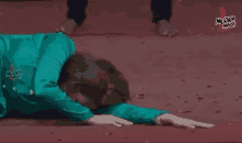 a person is laying on their stomach on a red carpet .