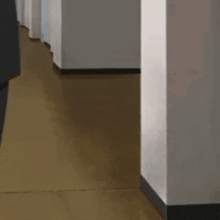 a cartoon cat is peeking out from behind a wall .