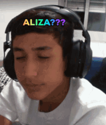 a young man wearing headphones has the word aliza on his forehead