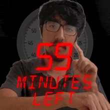 a man wearing glasses is pointing at the number 59