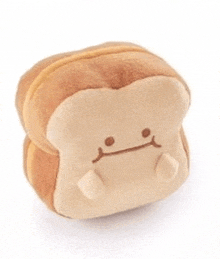 a stuffed sandwich with a sad face on it is on a white background .