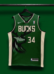 a green and white bucks jersey is hanging on a rack