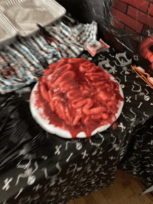 a plate of bloody brains on a table with a black table cloth