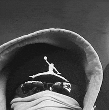 a black and white photo of a person wearing a hoodie with a jordan logo on it