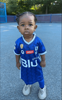 a little boy wearing a blue shirt that says blu