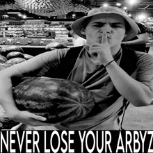 a man holding a watermelon with the words never lose your arbyz