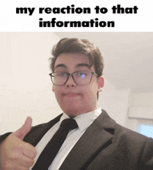 a man in a suit and tie is giving a thumbs up with the caption my reaction to that information