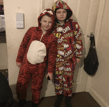 a boy in a tiger costume stands next to a boy in a comic book character costume