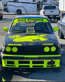 a black car with the word bad dragon written on the windshield