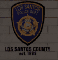 a los santos county police department emblem on a wall