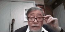 a man with glasses and a beard is looking at the camera while talking on a video call .