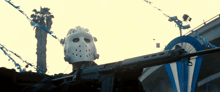 a person wearing a hockey mask holds a gun