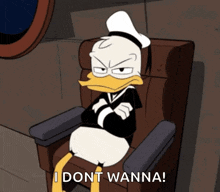 donald duck is sitting in a chair with his arms crossed and says " i dont wanna "