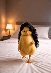 a chicken wearing a black wig stands on a bed
