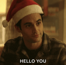 a man wearing a santa hat with the words hello you below him