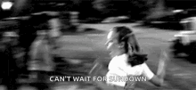 a black and white photo of a woman running in a field with the words `` can 't wait for sundown '' .