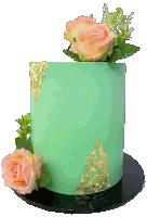 a green cake with pink roses and gold leaf