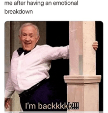 a man in a tuxedo is standing next to a pillar and says i 'm backkkk !!