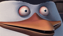 a close up of a cartoon penguin making a funny face with his eyes closed .