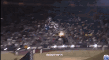 a man is riding a dirt bike down a dirt track at night ..