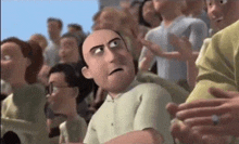 a cartoon man is sitting in front of a crowd of people clapping .