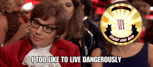 a man in a red jacket with glasses says i too like to live dangerously