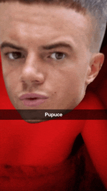 a close up of a man 's face with the word pupuce on the bottom