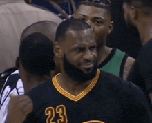 a man with a beard wears a jersey with the number 23 on it