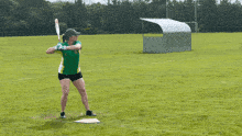 a woman in a green shirt is standing on a baseball field with the words not impressed behind her