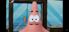 patrick star from spongebob squarepants is standing in front of a window