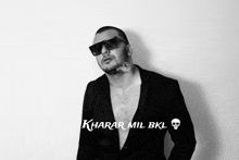 a black and white photo of a man with the words kharar mil bkl