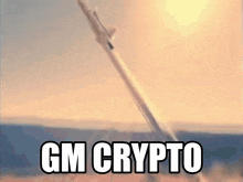 a rocket is being launched with the words gm crypto written on the bottom