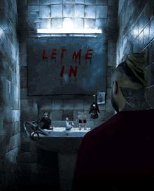 a man sits in a bathroom with a sign that says let me in