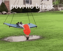 a child is laying upside down on a swing in the grass with the words pov : no break written above him .