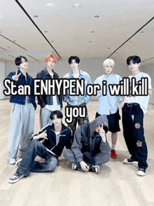 a group of young men posing for a picture with the caption stan enhypen or i will kill you .