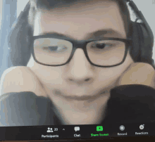 a man wearing glasses and headphones is on a zoom call with 20 participants