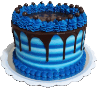 a blue cake with chocolate drips and chocolate balls