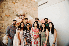 a group of people posing for a picture with a pregnant woman