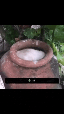 a clay pot with a white substance in it and the words talk at the bottom