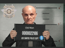 an old man is holding up a los santos police dept mug shot