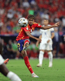 a soccer player with the number 19 on his shorts kicking a ball