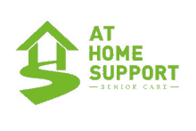 the logo for at home support senior care is a green house with a path leading to it .