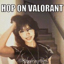 a woman in a black shirt is standing in front of stairs and a sign that says hop on valorant