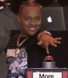 a man pressing a button that says more on it