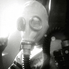 a person wearing a gas mask with a hose around their neck