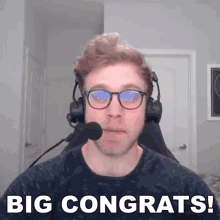 a man wearing glasses and a headset says big congrats